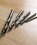 5-piece set of Left Hand Drill Bit For Metal Working With Cobalt M35 Steel Split Point Tips on wooden surface