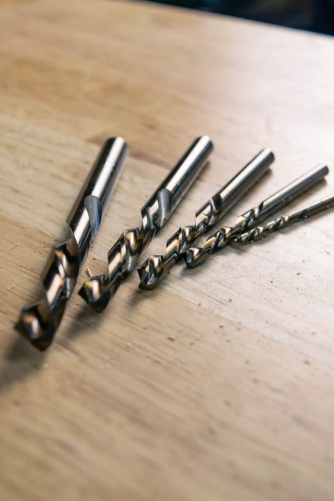 5-piece set of Left Hand Drill Bit For Metal Working With Cobalt M35 Steel Split Point Tips on wooden surface