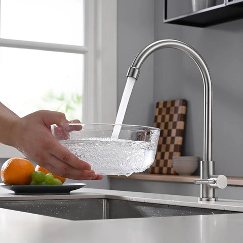 A Total Game Changer For Your Modern Kitchen Or Home Bar With This Dependable Cold Water Only Faucet Finished In Smooth Brushed Nickel and Built Darn Tough From Pure Food Grade 304 Stainless Steel pouring water into a bowl.