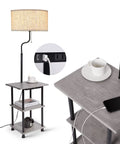 Solid Rubber Wood Floor Lamp With Table And USB Type C Charging Port And Outlet Three Tier Shelf Nightstand Rustic Tall Standing Lamp For Living Room Bedroom And Office LED Bulb Included showing shelf detail with cup and phone charging.