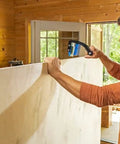 Man using Panel Carrier For Plywood Sheets And Large Panels With Ergonomic Grip One Handed Carry Up To 100 Lbs Heavy Duty Carpentry Tool