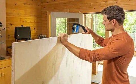 Man using Panel Carrier For Plywood Sheets And Large Panels With Ergonomic Grip One Handed Carry Up To 100 Lbs Heavy Duty Carpentry Tool