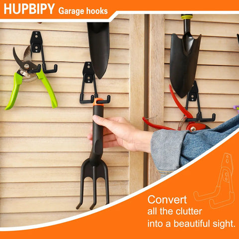 Person hanging tools on wall with Four Pack Five Point One Inch Heavy Duty U Shaped Garage Hooks Wall Mounted Tool Organizer
