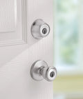 Close-up of Tylo Entry Knob and Single Cylinder Deadbolt Combo 1 Pack Satin Chrome with Adjustable Latch on white door