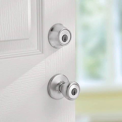 Close-up of Tylo Entry Knob and Single Cylinder Deadbolt Combo 1 Pack Satin Chrome with Adjustable Latch on white door