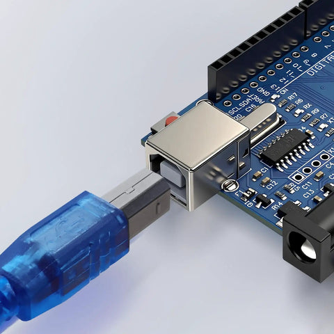 Close-up of an Arduino Compatible ATmega328P Microcontroller Board with USB cable connected, showing digital I/O pins.