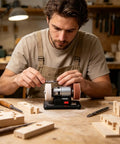 Man using Built Different Mini Bench Grinder With Knockout Torque From A Copper Brushless Motor for wood sharpening tasks.