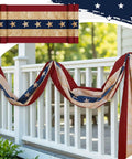 Patriotic Flag Bunting Set, 2 Pack Of 2x20 Ft Outdoor Banners draped on white porch railing showing red, white, and blue stars.