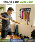 Man using resistance bands with Built Like A Tank Wall Mounted Workout Gear Organizer Rack with heavy duty hooks.