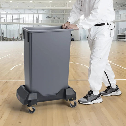 Heavy Duty Trash Can Dolly Featuring Slick 4 Way Swivel Casters Fitting 16 And 23 Gallon Bins Built Tough For No Sweat Waste Moving Up To 200 Lbs Capacity in a gym setting.