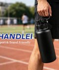 Bulk 8 Pack 32 Oz Double Wall Vacuum Insulated Stainless Steel Water Bottle With Leak Proof Flip Lid And Tote Handle, black stainless steel bottle with carry handle in outdoor setting.