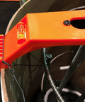 Close-up of Orange 24 Inch Bolt Template Tool For Nested 24 And 25 Inch Tubes with Level and Four Arm Design on concrete tube.