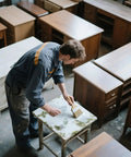 Top Shelf Oxalic Acid Wood Bleach One Pound Powder Formula being applied by a person on a table in a shop.