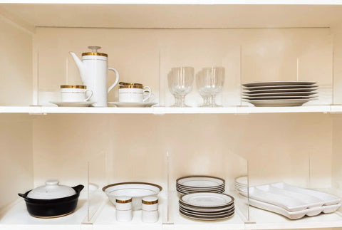 8 Pack Acrylic Shelf Dividers for Closet Organization holding dishes and glasses, clear adjustable storage spacers on wooden shelf.