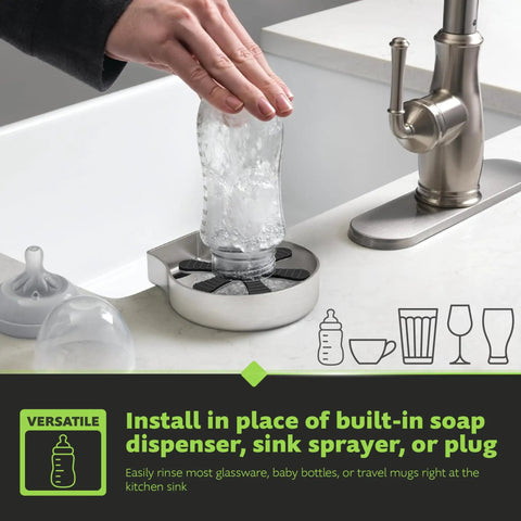 Hand using Straight Fire Stainless Steel Glass Rinser for quick rinse of baby bottle at kitchen sink, sleek design.