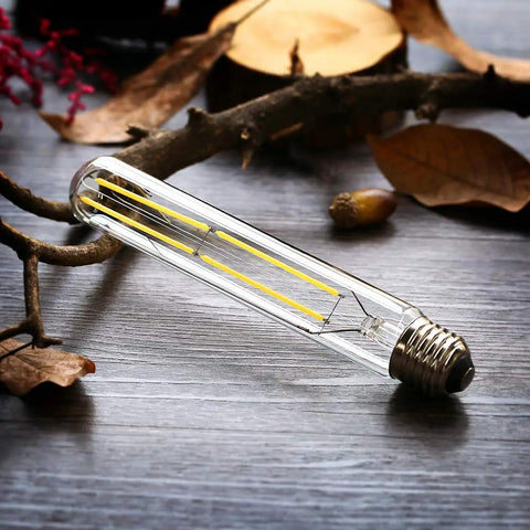 Dimmable T10 LED Filament Tubular Bulbs 4000K Daylight White, 6W Edison Style, 60W Equivalent, on wooden surface with leaves
