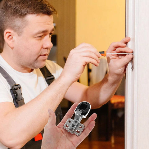 Man installing soft close glass cabinet hinges on kitchen door.