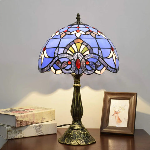 Blue Baroque Tiffany Style Stained Glass Table Lamp For Bedroom And Living Room, 12x12x18 Inch, on a wooden desk.
