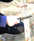 Person using Straight Outdoor Survival Knife With Leg Straps And Sheath, Razor Sharp And Lightweight Go To Dive Gear for cutting branch