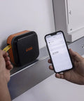Person using Portable Industrial Label Printer With Bluetooth And Pro Label Tool App to print labels near a panel