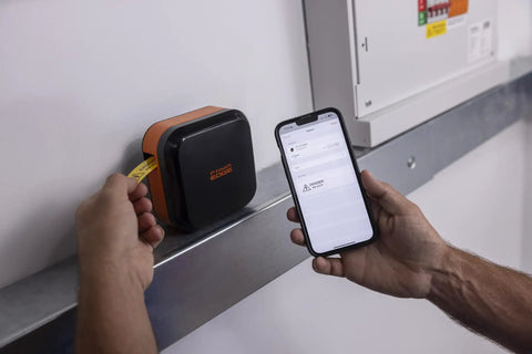 Person using Portable Industrial Label Printer With Bluetooth And Pro Label Tool App to print labels near a panel