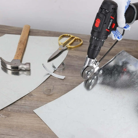 DIY Sheet Metal Nibbler Attachment For Drill 2025 in use cutting sheet metal with hammer and scissors nearby on workbench.