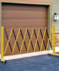 Heavy Duty Yellow And Black Folding Security Gate Built Like A Tank With Top Shelf Craftsmanship Smooth Rolling Casters And Quick Expand Adjustable Scissor Barrier For No Sweat Crowd Control in use, blocking entrance.