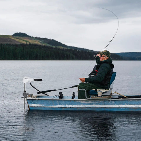 Electric Trolling Motor For Kayaks And Fishing Boats, 12V 55 Lbs Thrust on a boat in freshwater lake with angler.