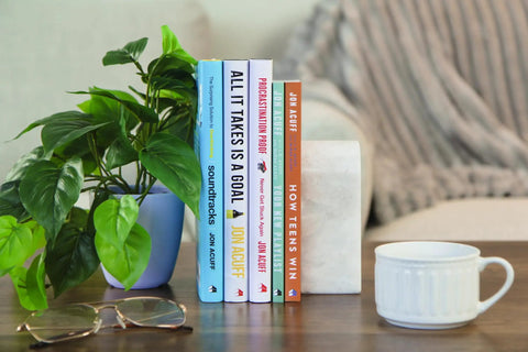 Fresh Start Blueprint A Straight Fire Guide To Level Up Your Life Mindset And Crush Major Changes In This Rock Solid Self Help Manual For Determined Go Getters Ready on a table with a plant and cup.