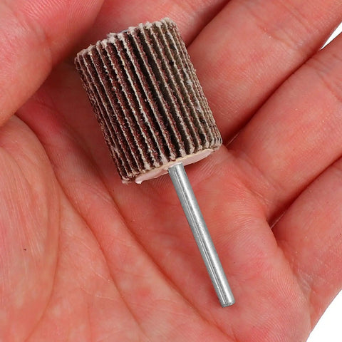 Close-up of a Dual Layer Abrasive Flap Wheels 50 Piece Drill Sander Attachment for Steel Ceramics and Glass That Tackles Stubborn Stains Like a Pro shown in hand.