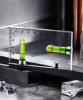 RuiJOTWAT Clear Magnetic Spirit Level Dual Direction Mini Spirit Level Tool For Carpentry Diy Projects next to measuring ruler.
