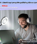Man using laptop with 2-in-1 desktop lamp and magnifying glass providing 850 lux illumination, featuring no glare or distortion.