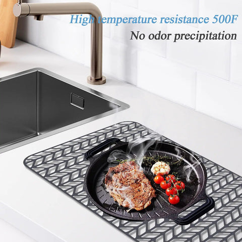 Silicone Sink Protector Mat 26 By 14 Inches For Kitchen Sink Dishes And Glassware Rust Proof Durable No Slip With One Quarter Inch Feet For Noise Reduction Keeps Sink And Tableware Scratch Free under a hot pan on kitchen counter.