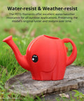 Red elephant-shaped watering can made with Black PETG 3D Printer Filament 1.75mm 1 Kg Reusable Spool, outdoors on a wooden surface.