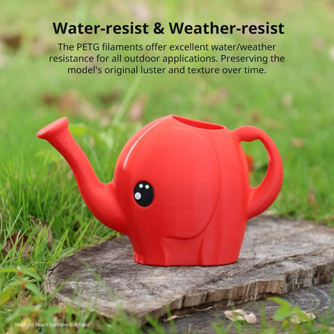 Red elephant-shaped watering can made with Black PETG 3D Printer Filament 1.75mm 1 Kg Reusable Spool, outdoors on a wooden surface.