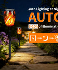 Solar Torch Light With Waterproof Outdoor Design Dusk To Dawn Auto On Off Flickering Flame Effect In Orange Glow installed along garden pathway