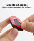 Close-up of AirTag Adhesive Security Mount TagVault Low Profile Holder With 3M VHB Adhesive, held by fingers, showing easy installation.