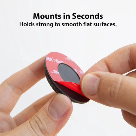 Close-up of AirTag Adhesive Security Mount TagVault Low Profile Holder With 3M VHB Adhesive, held by fingers, showing easy installation.