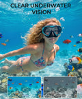 Woman wearing Snorkel Mask For Adults And Teens, Leak-Proof Swim Goggles with 180-Degree Panoramic View underwater, surrounded by fish.