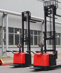 Heavy Duty Electric Hand Pallet Jack Stacker With 3000mm Lift Height For Warehouse Floor, showcasing two red stackers beside a manual pallet jack.