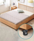 Heavy Duty Black Furniture Stopper 4 Pack Non Slip Rubber Wheel Cups under a wooden bed on hardwood floor for stability.
