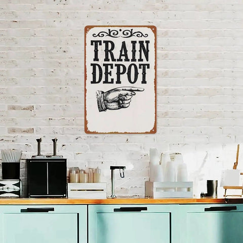 Train Depot Aluminum Wall Decor 12x8 Inch sign with a pointing hand on white brick wall in kitchen setting.