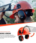 Forestry Safety Helmet With Adjustable Earmuffs And Visor, Orange Hard Hat in use showing 90-degree visor adjustment.