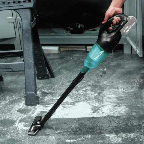 Person using 18V LXT Cordless Vacuum with Redesigned Floor Nozzle for easy maneuvering on concrete floor