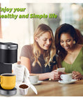Image featuring two women enjoying coffee near a coffee maker with Disposable K Cup Coffee Filters With Lid For Single Serve Brewers 1.0 And 2.0.