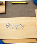 6 Pack Rock Solid Sliding Door Rollers With Galvanized Nylon Tracks For Cabinets And Furniture on a wooden surface with tools.