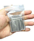 Hand holding 64 Pack 5mm x 40mm Dowel Pins for Shelves and Furniture, 304 Stainless Steel Wood Pegs For Tight Fits, Ground Precision Tolerances, Built Tough Metal Dowel Rods For Everyday Repairs in a clear bag