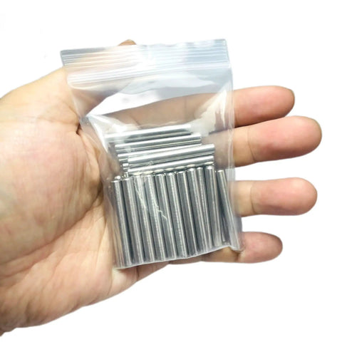 Hand holding 64 Pack 5mm x 40mm Dowel Pins for Shelves and Furniture, 304 Stainless Steel Wood Pegs For Tight Fits, Ground Precision Tolerances, Built Tough Metal Dowel Rods For Everyday Repairs in a clear bag