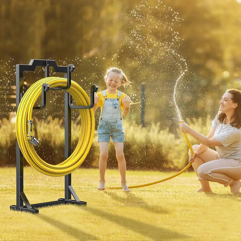 Image of a black garden hose reel holder with four foot design keeping a yellow hose tidy in a sunny yard.