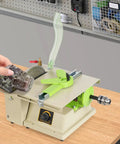 Beast 1380W Mini Table Saw and Jewelry Polisher adjusts speed on wood bench with hand holding jade stone for cutting.